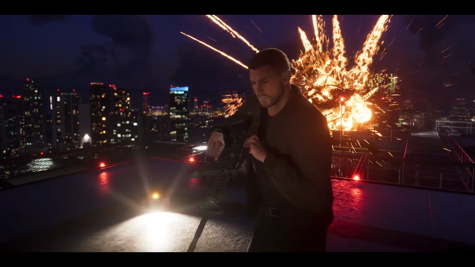 GTA 6 Launch Trailer: a short-haired man in a dark jacket holds a rifle on a night helipad as an explosion sprays sparks behind him