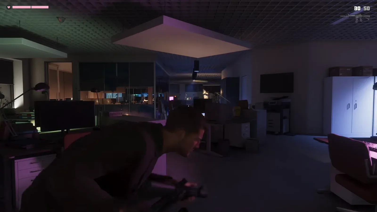 GTA 6 Extended Look: Jason moves low through an office holding a rifle after the pickup, the HUD now showing an assault rifle at 30 and 50