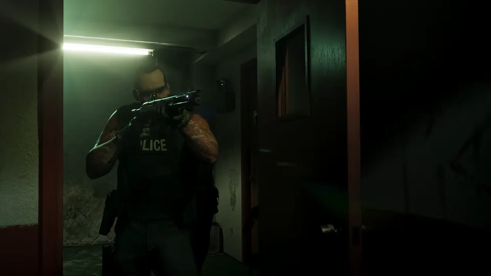 GTA 6 Extended Look: a police officer in a vest aims a pump shotgun with a small light near the muzzle down a dim drug lab corridor