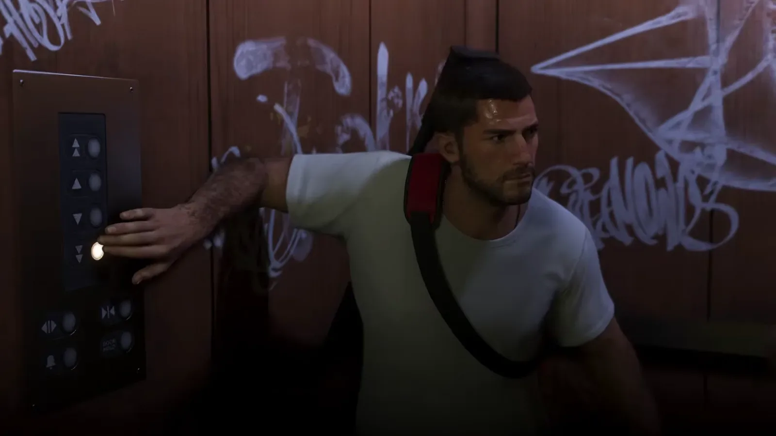 GTA 6 Extended Look: Jason presses an elevator button with a long gun slung on his back, its end showing behind his head, both hands free