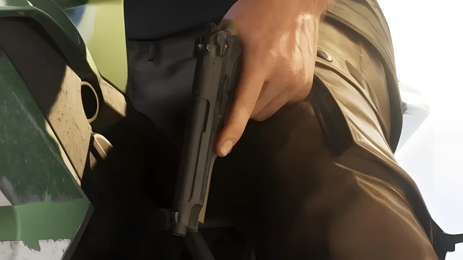 Close-up of a black semi-automatic pistol holstered at a man's waist, from an official GTA 6 screenshot
