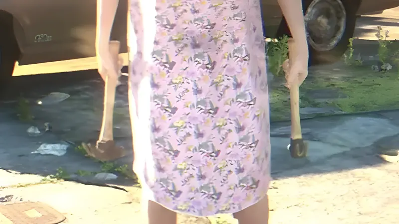 Person in a floral dress holding a hammer in each hand on a driveway, from the first official GTA 6 trailer