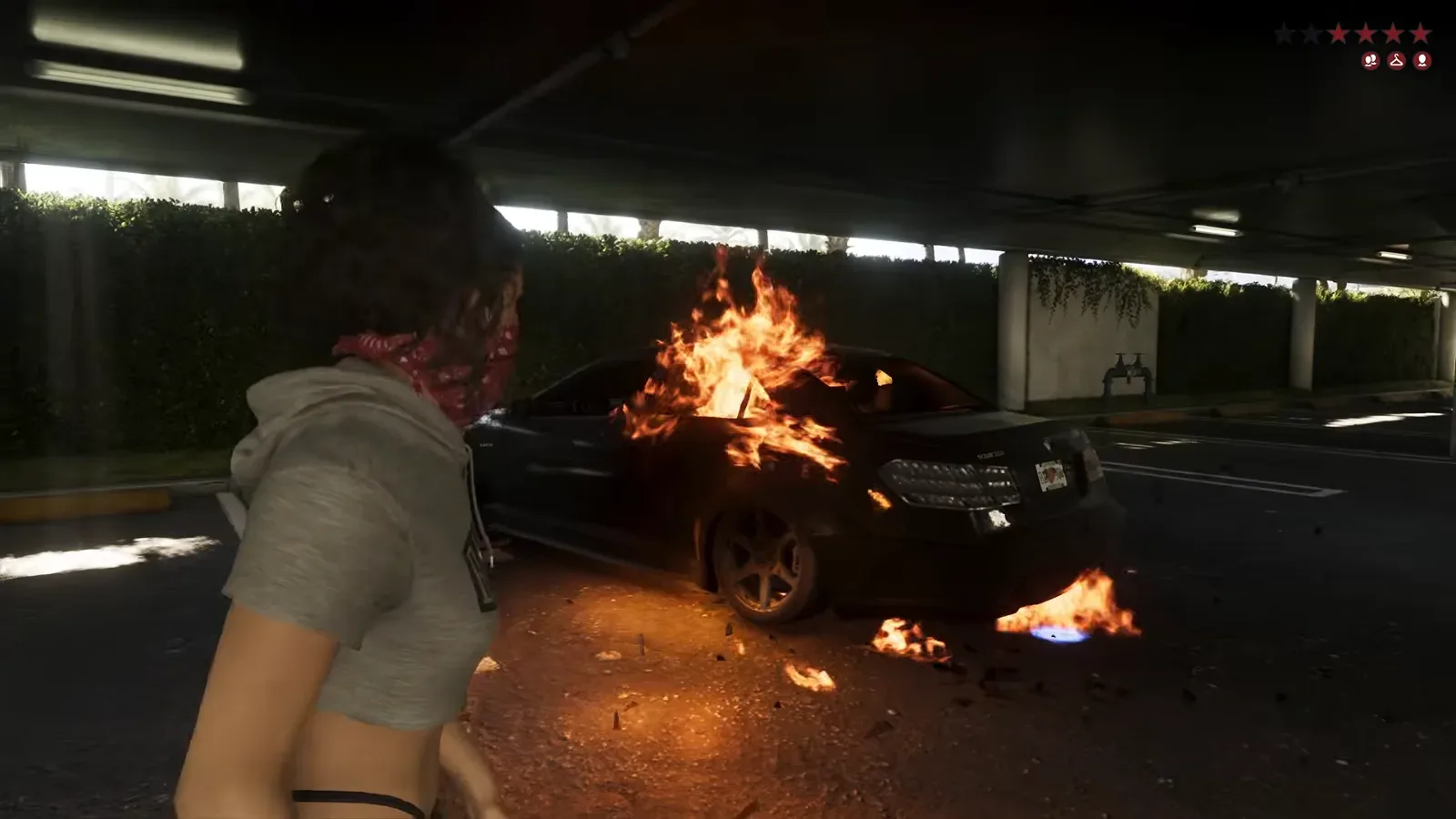 The black sedan beside Lucia burns in a parking garage after the Molotov, flames on the door and the ground, GTA 6 Extended Look at 16:05